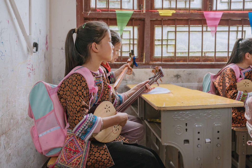 Bendi Stories: Teaching Dong Music in Huanggang Village, Guizhou One of Wu Xianliang's students playing the Dong pipa