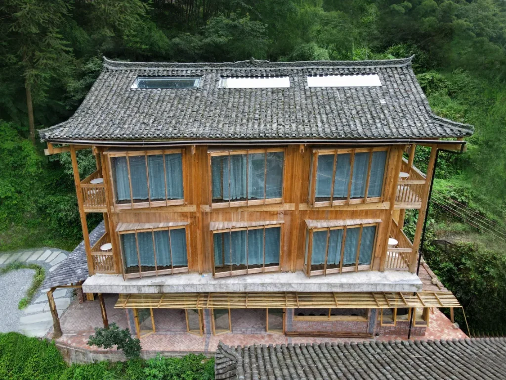 WildChina introduces the Best Boutique Hotels in China (2024) - The Well House in Dali Dong Village, perched on lush mountainside.