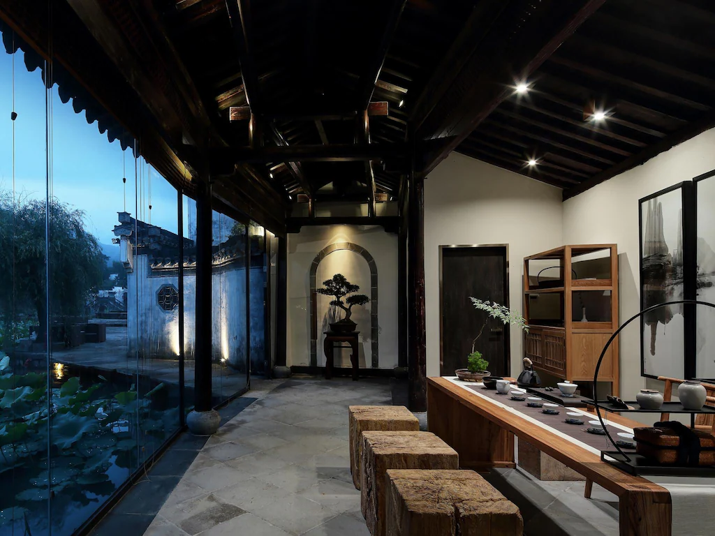 WildChina introduces the Best Boutique Hotels in China (2024) - Su House’s refined interior, softly illuminated at night.