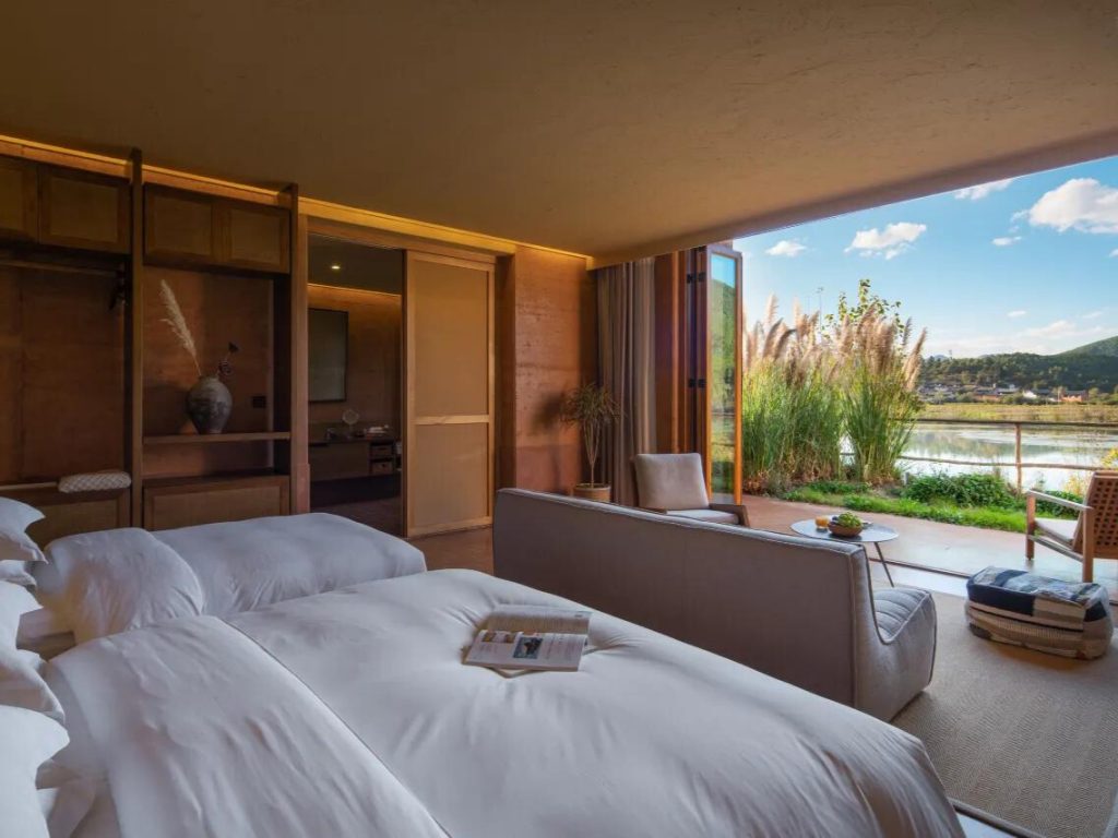 WildChina introduces the Best Boutique Hotels in China (2024) - Guest room at the Linden Center, with serene views of Shaxi’s nature.