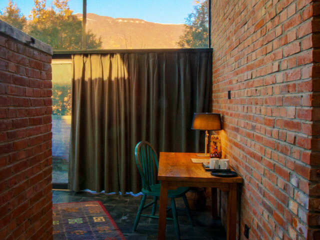 WildChina introduces the Best Boutique Hotels in China (2024) - Inviting interiors and views of the Great Wall at Brickyard Retreat.