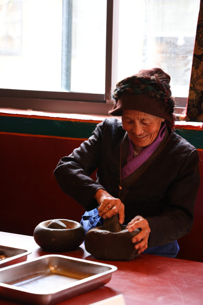 Making Tibetan Incense in Sangpu Village Making Tibetan Incense in Sangpu Village: Grinding ingredients with a stone mortar and pestle.
